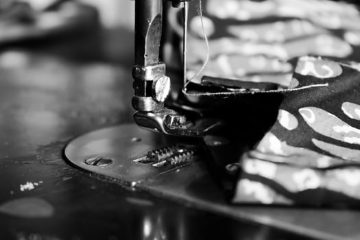 Vintage Black and White, Close up Sewing machine sews batik indonesian fabric into cloth, vintage black and white concept photo