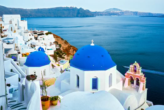 Famous view from viewpoint of Santorini Oia village with blue dome of greek orthodox Christian church photo