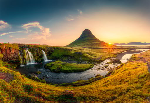 Sunrise over volcanic Kirkjufell mountain with waterfall flowing in summer at Iceland photo