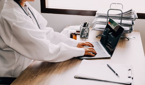 Online training. Young Latin American girl student doctor studies online at home from laptop photo