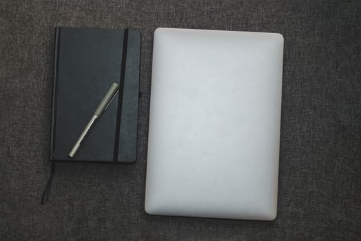 Laptop series flat metal on the table with a business diary photo