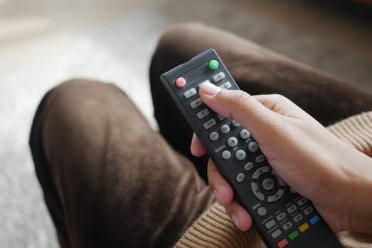 close up of women hand holding tv remote. photo