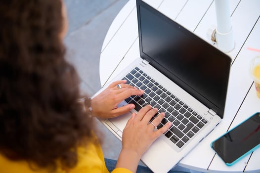 Overhead view of woman typing text on laptop keyboard, blank mockup screen, working remotely. Online Business. Education photo