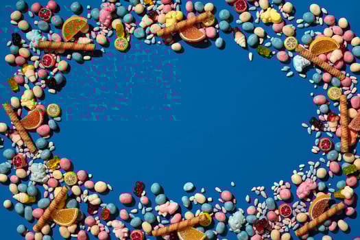 Photo of candies dragee placed on the perimeter of image with a copy space in the middle