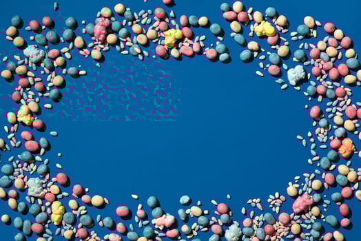 Photo of candies dragee placed on the perimeter of image with a copy space in the middle