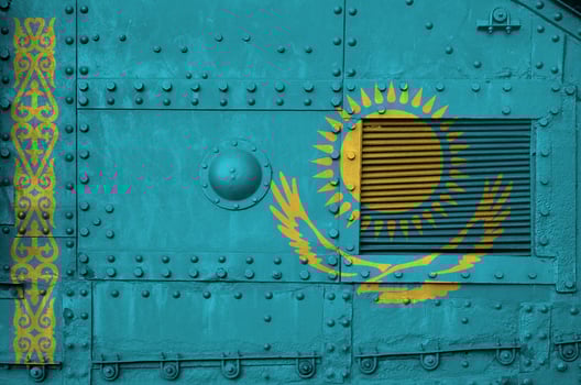 Kazakhstan flag depicted on side part of military armored tank closeup. Army forces conceptual background photo