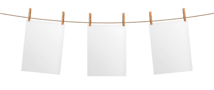 Empty paper sheet hanging on rope, isolated on white background photo