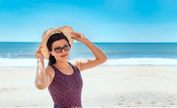 woman in hat happy on the beach, happy pretty young woman on vacation, vacation concept photo