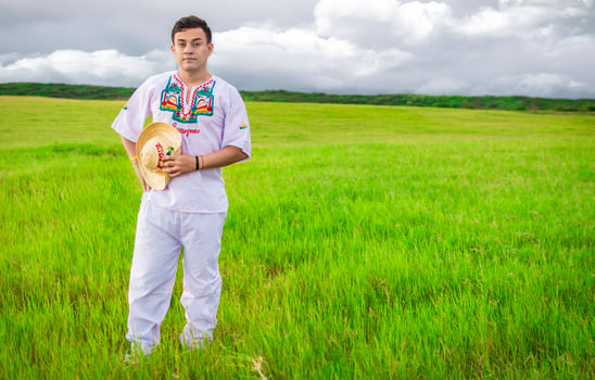 Nicaraguan man in folk costume in the field, Man wearing Central American folk costume. Young man in cultural and folk costume from Nicaragua. Concept of man in Nicaraguan folk costume photo