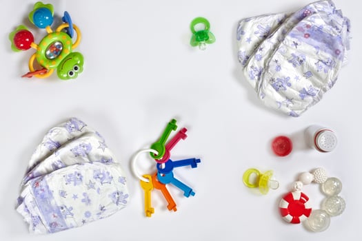 Babies goods diaper, soother or nipple on white background with copy space. Top view or flat lay. photo