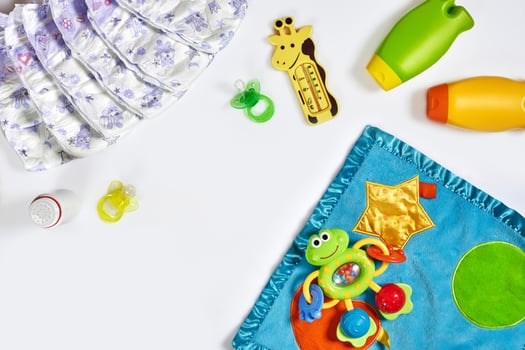 Set of accessories for baby. Pacifier, bottle, diaper, cream on white background. photo