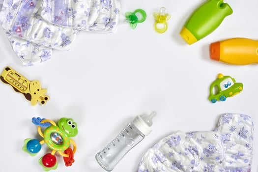 Set of accessories for baby. Pacifier, bottle, diaper, cream on white background. photo