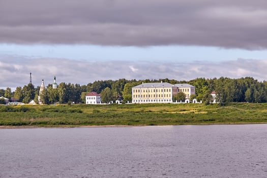 Scenic view of a old manor house by a river photo