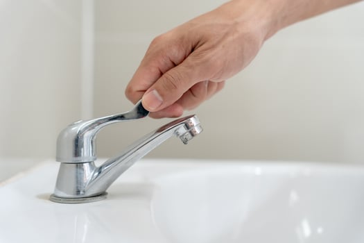 Save water. Volunteer keeps turning off the running water in the bathroom to protect environment. Greening planet, reduce global warming, Save world, life, future, risk energy, crisis , water day. photo