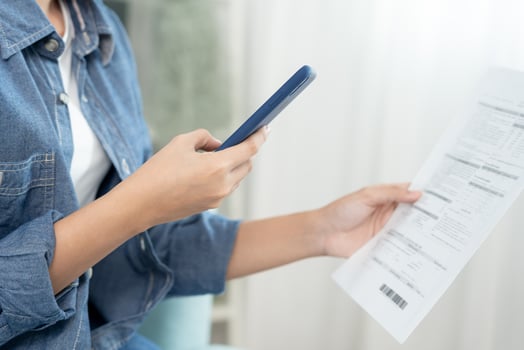 Modern woman use phone to scan barcode or QR codes to pay credit card bill after receive document invoice. payment, receive, paying electricity, digital payments without money, technology, scanning photo