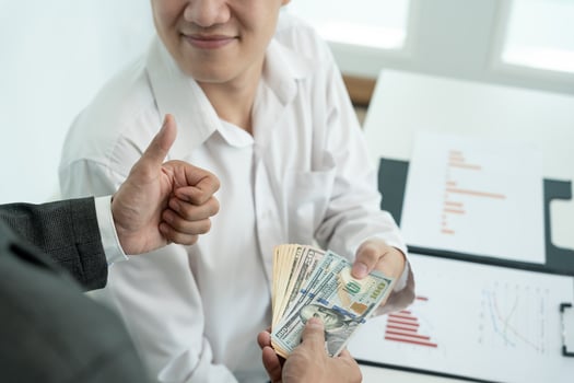 Businessmen receive salary or bonuses from management or Boss. Company give rewards to encourage work. Smiling businessman enjoying a reward at the desk in the office. photo
