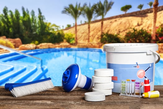 Equipment with chemical cleaning products and tools for the maintenance of the swimming pool. photo