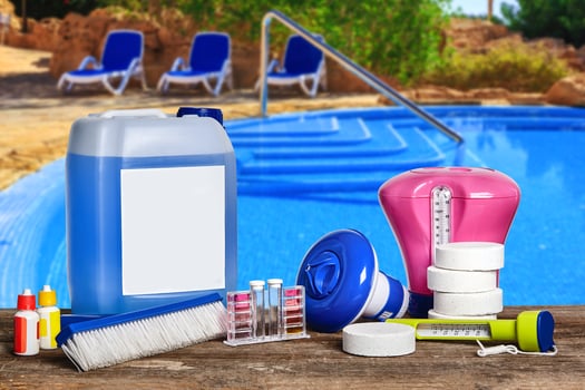 Equipment with chemical cleaning products and tools for the maintenance of the swimming pool. photo