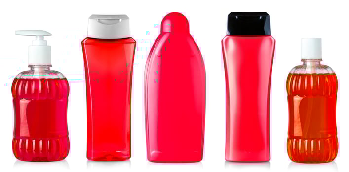 Red shower gel bottles isolated on white photo