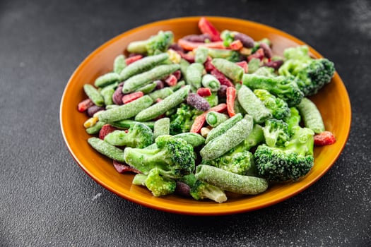 frozen vegetables mix broccoli, corn, carrots, green peas, green beans, bell peppers, beans fresh delicious healthy eating cooking appetizer meal food snack on the table photo