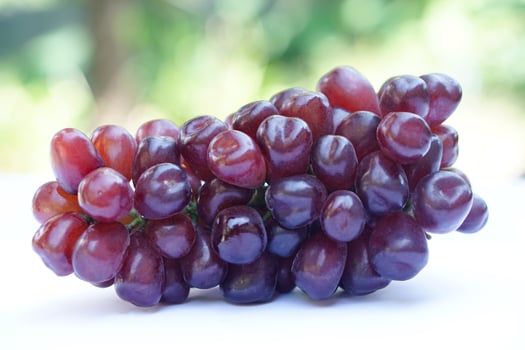 Bunch of fresh seedless red grapes, fruits , outdoor background. Concept, Healthy eating. Agricultural crops. photo