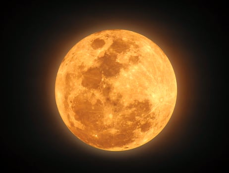 The yellow full moon on black background photo
