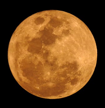 The yellow full moon on black background photo