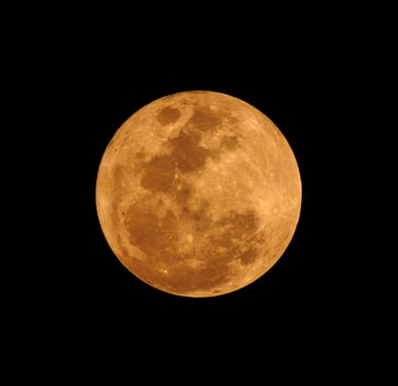 The yellow full moon on black background photo
