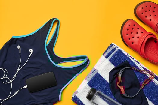 Flat lay summer pool accessories on a yellow background. Colorful beach wear. photo