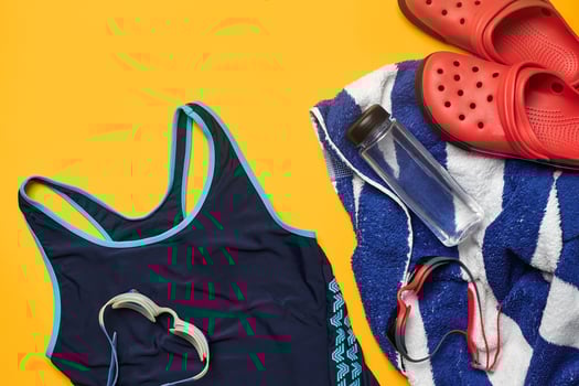 Flat lay summer pool accessories on a yellow background. Colorful beach wear. photo