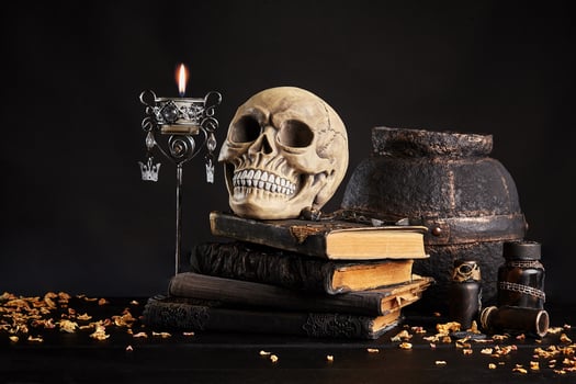 Realistic model of a human skull with teeth on a wooden dark table, black background. Medical science or Halloween horror concept. Close-up shot. photo