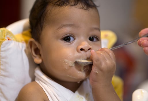 Asian baby boy eat food sloppy photo