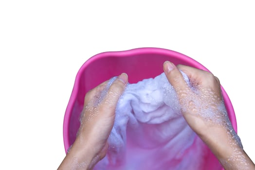 Hand washing clothes in the basin. photo