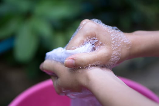 Hand washing clothes in the basin. photo