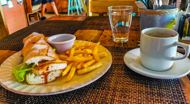 Baguette sandwich toast bread with chicken tomato salad potatoes fries. photo