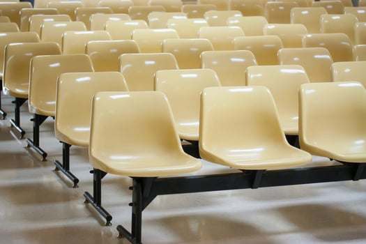 empty yellow plastic chairs in many rows photo