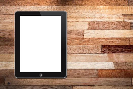 Tablet pc on wooden background photo
