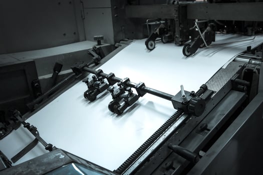 Close-up view of a printing press mechanism in operation, crisp engineering detail and precision movement, representing technology, durability, and professional industrial craftsmanship. photo