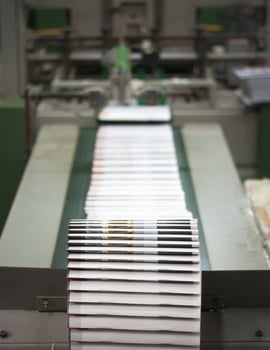 Printing conveyor transporting freshly printed sheets along the production line, illustrating scale, efficiency, and modern workflow in commercial publishing and packaging operations. photo