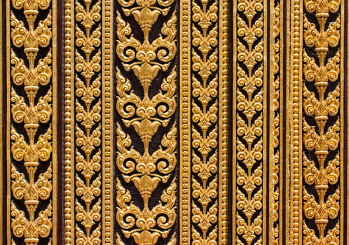 Golden decorative pattern on the wall of a building photo
