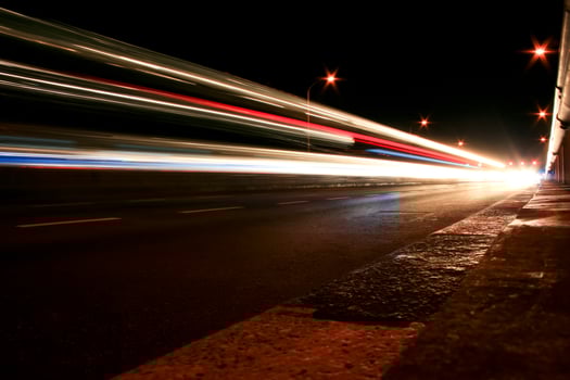 A blurry image of a street at night photo