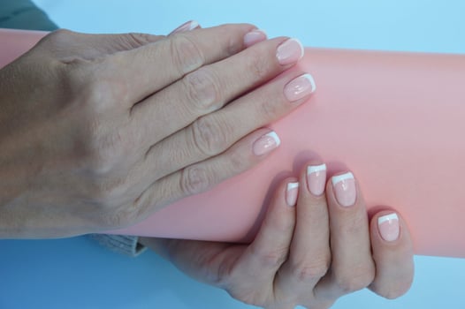 French manicure. Women's hands with beautiful manicured nails. Spa treatments and skin care photo