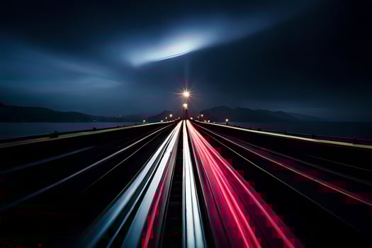 a long exposure photograph of a train track at night. AI-Generated photo