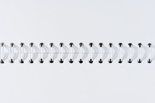 Open spiral notepad with blank white sheets photo