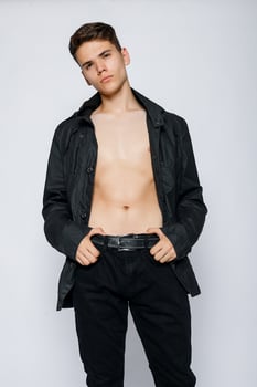 Young muscular man in a black jeans photo
