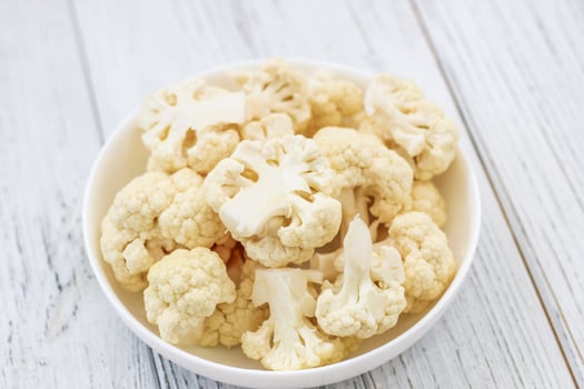 Cauliflower vegetables standing on a white wooden table photo