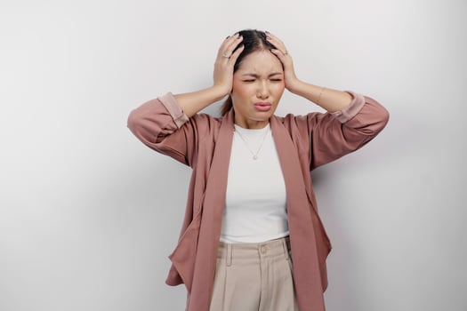 A sad Asian woman employee wears cardigan, looks stressed and depressed, isolated white background. photo