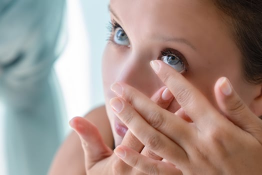 How to put contact lenses Step by step photo instruction. Step 3 girl pulled back her lower eyelid and brought contact lens to her eye to put.
