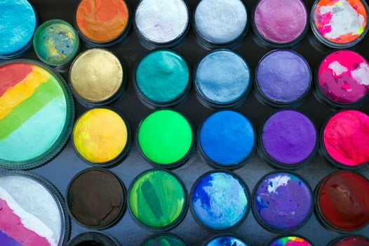 Set of multicolored paints for drawing on the face, close up photo