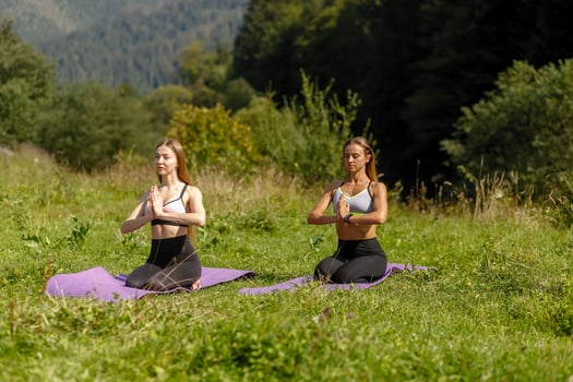 Fitness women in triangle pose while practising yoga at a park. photo